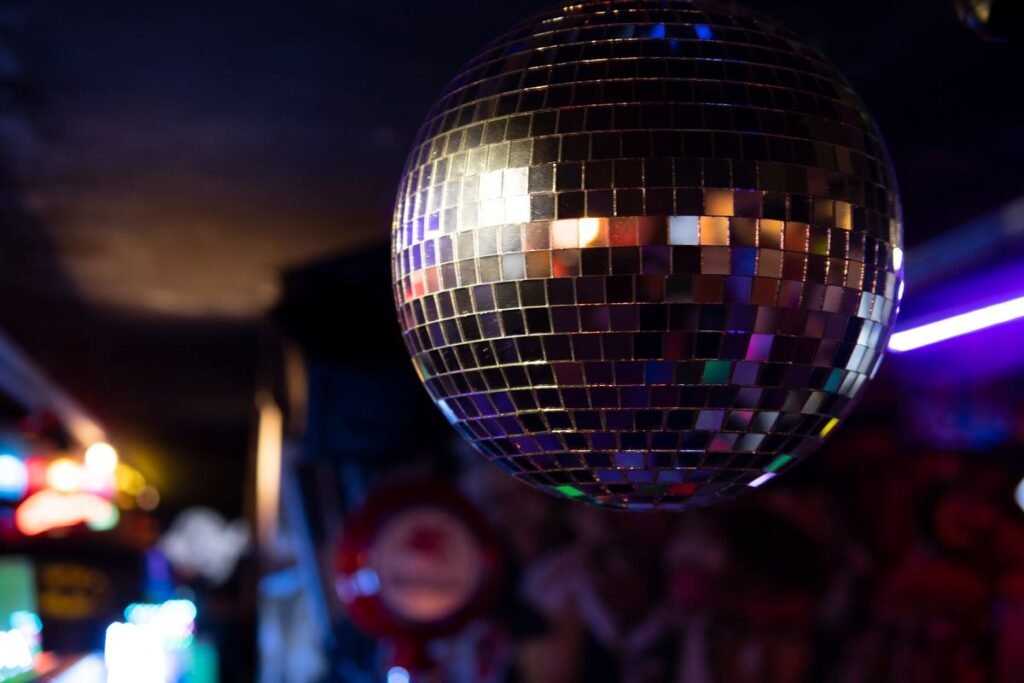 Disco ball reflecting light in a dark nightclub interior