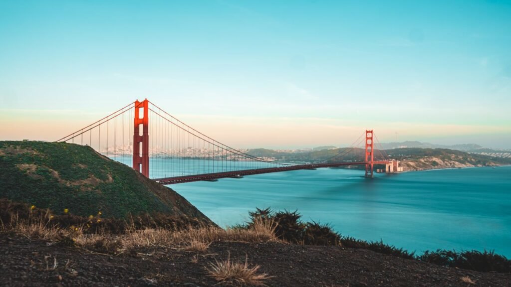 The Golden Gate Bridge seen from a headland above the bay at dusk