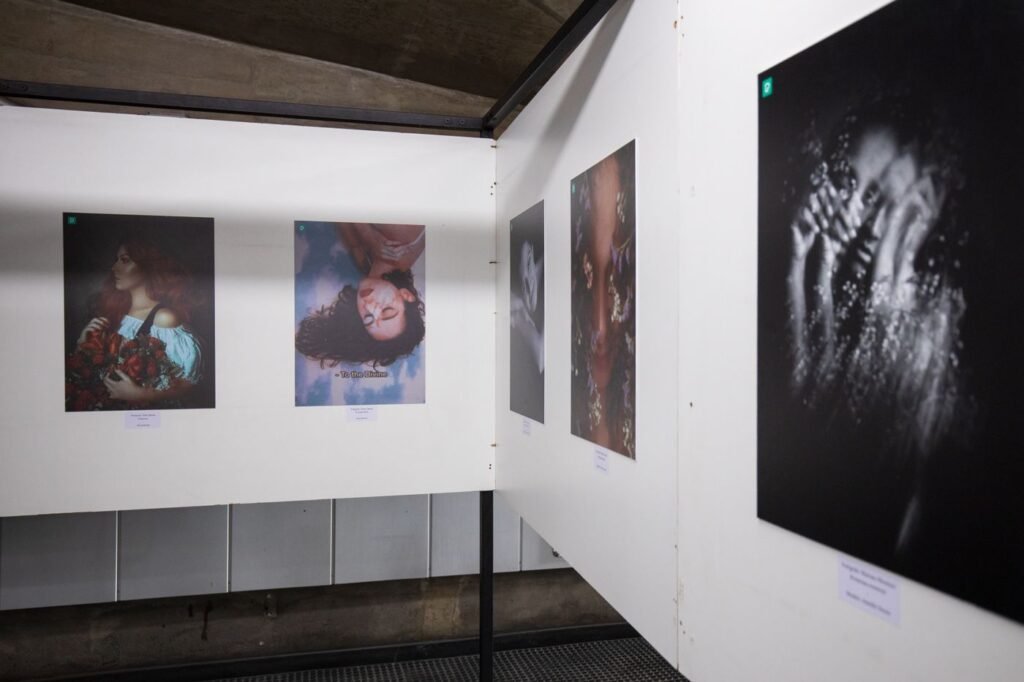 A wide warehouse gallery with large works on the walls