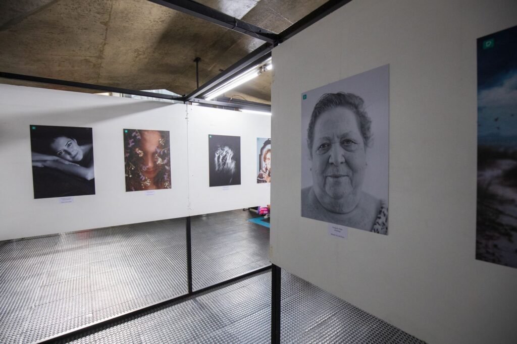 Photographs hung along a white gallery wall