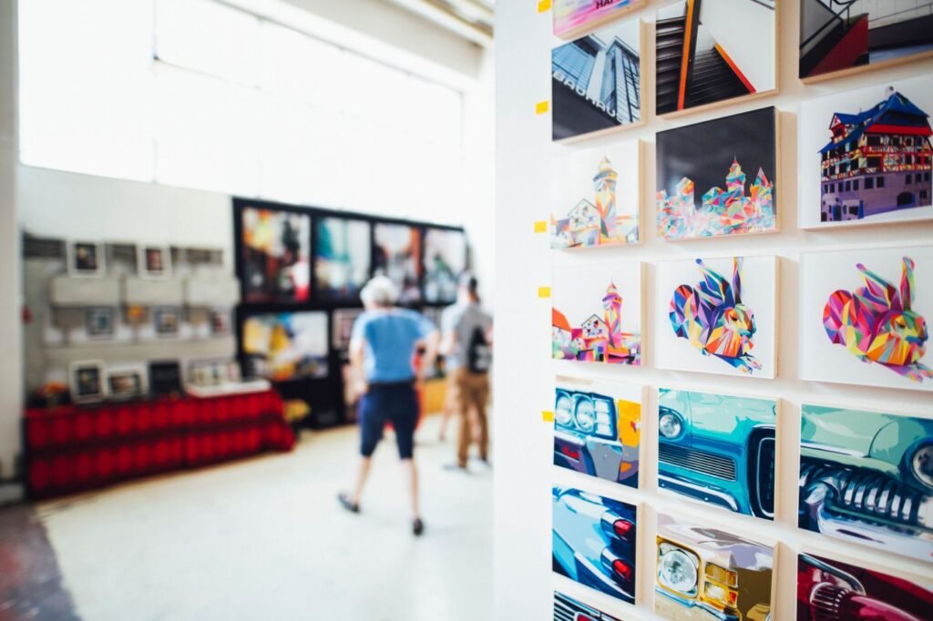 Brightly coloured prints and artwork filling a wall