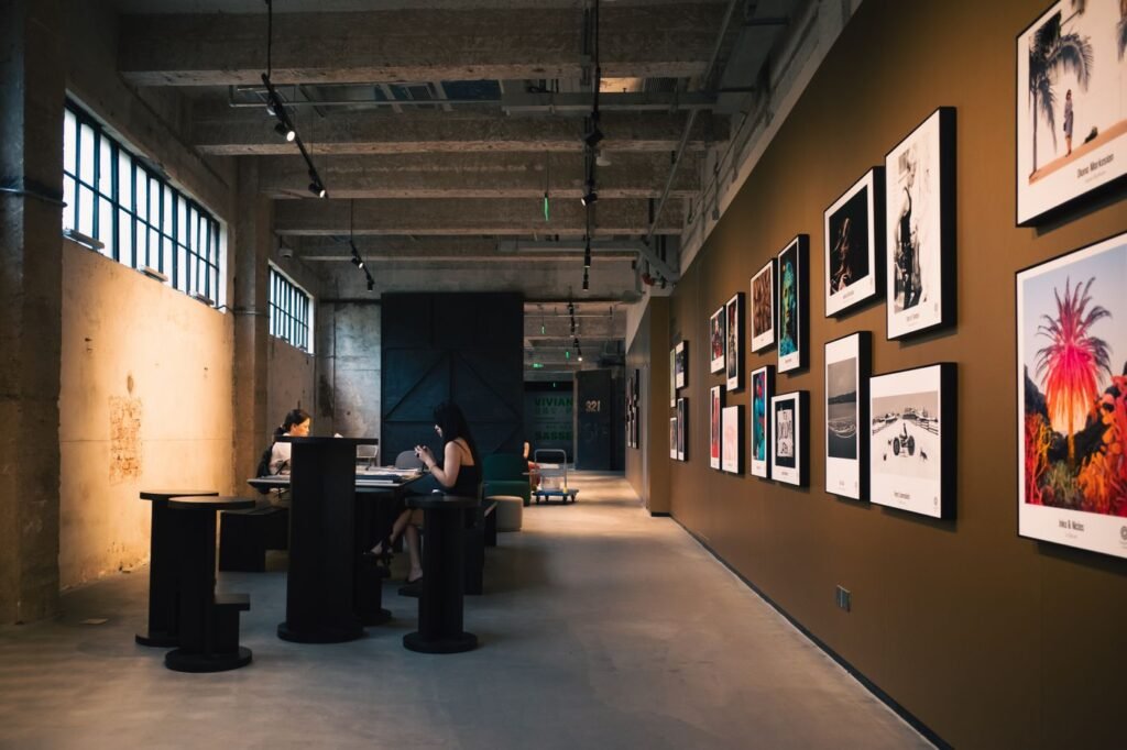 An open warehouse gallery with artwork along one wall