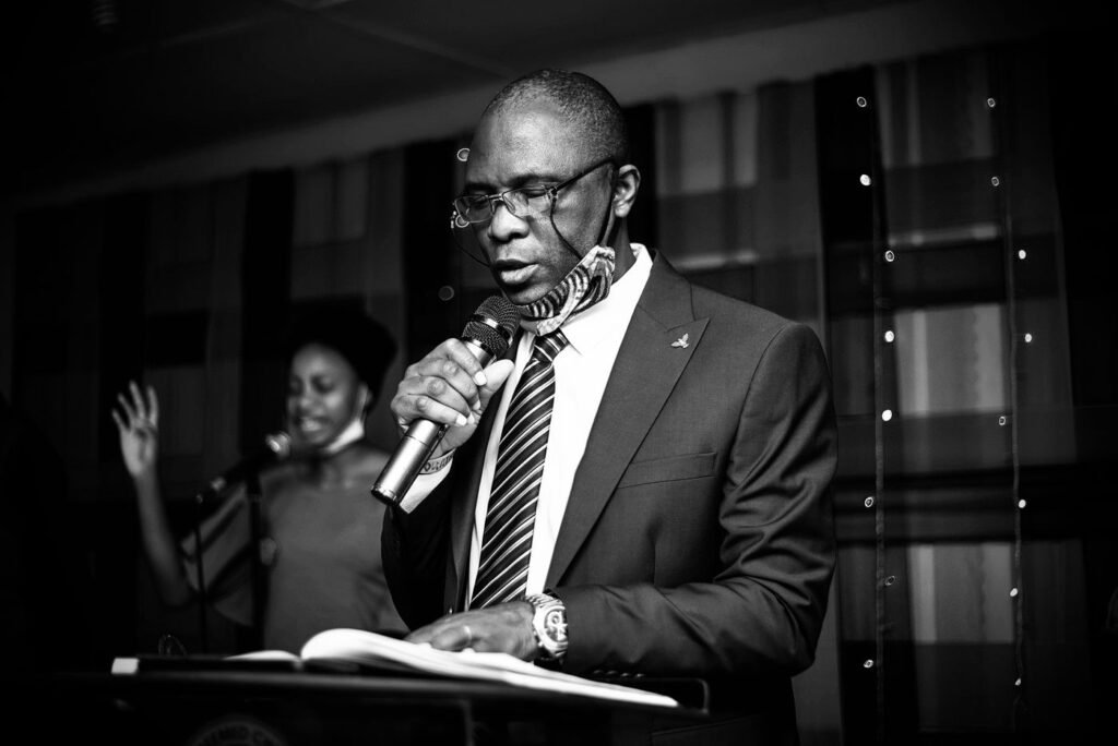 A speaker reading at a lectern