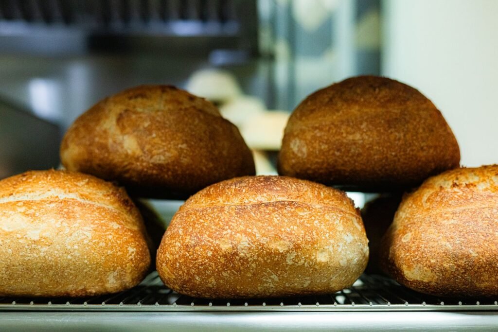 Freshly baked artisan sourdough loaves on a cooling rack