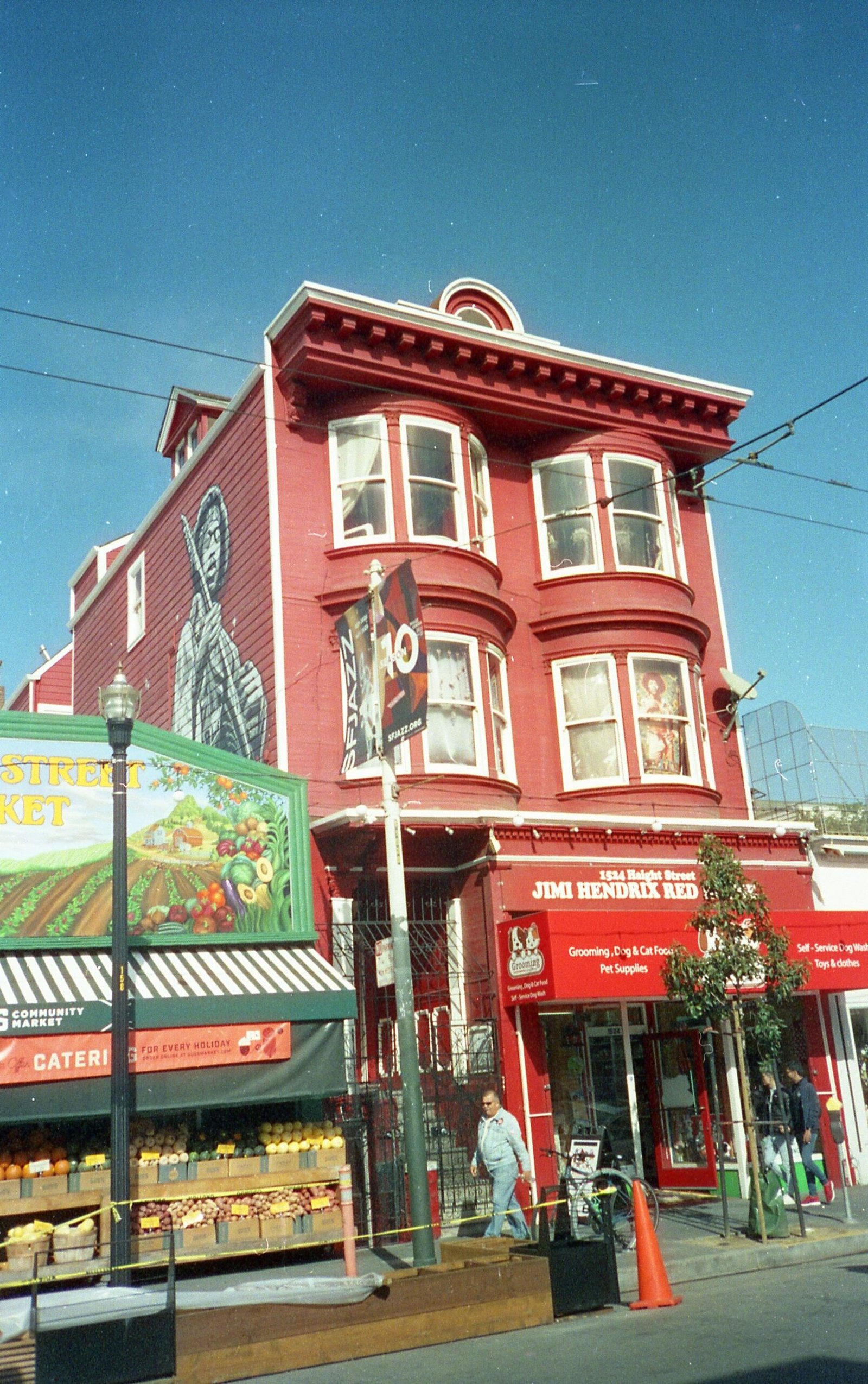 A vibrant red building with mural art in Haight-Ashbury, San Francisco