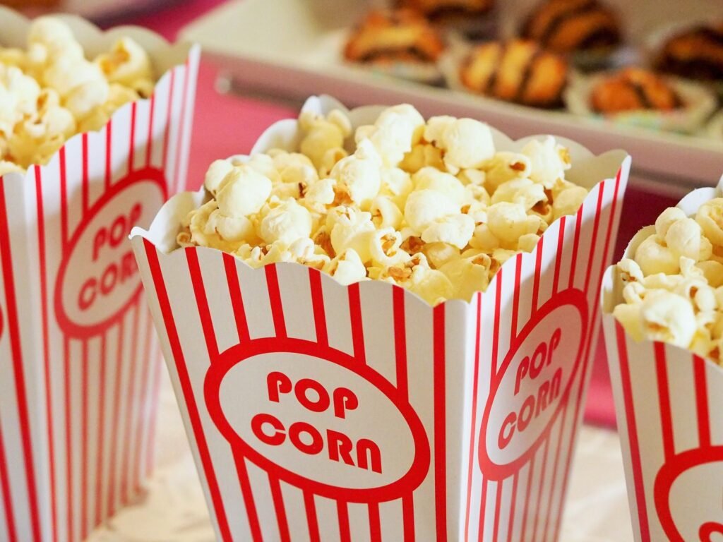 Close-up of buttered popcorn in classic red-and-white striped boxes