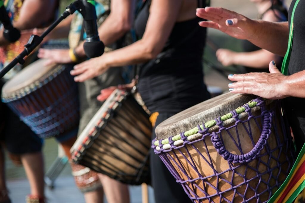 Hands playing djembe drums