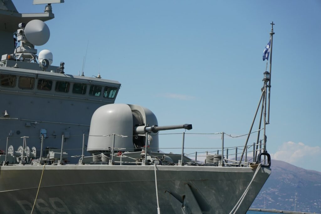 Navy ship deck and gun mount at a pier