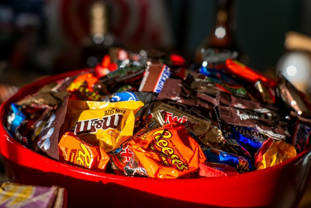 A red bowl filled with Halloween candy