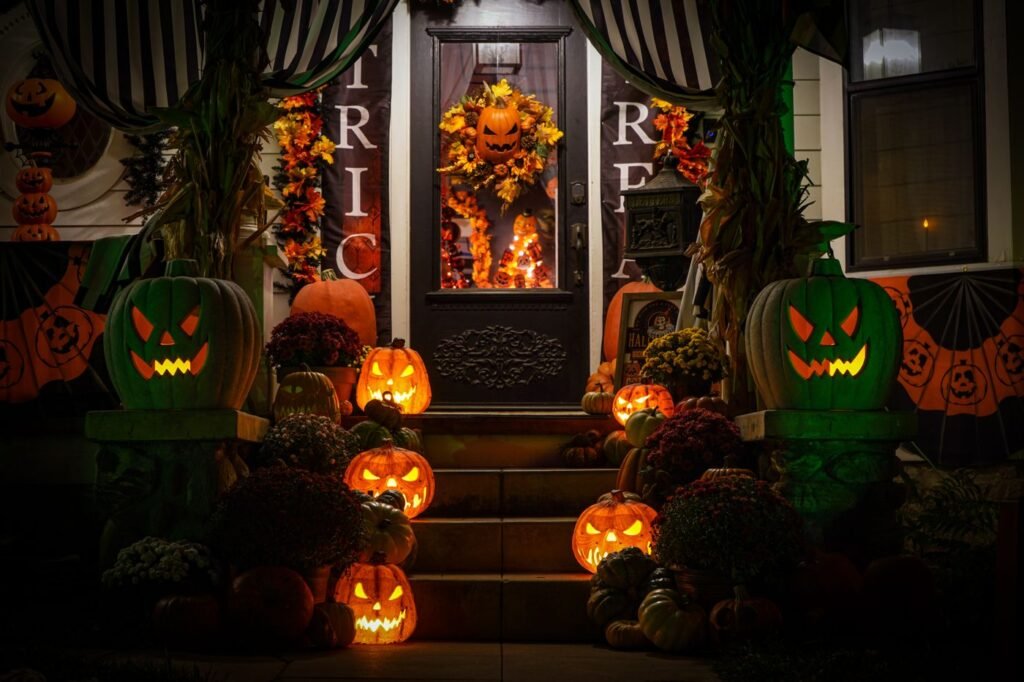 Glowing jack-o'-lanterns on the steps of a decorated porch at night