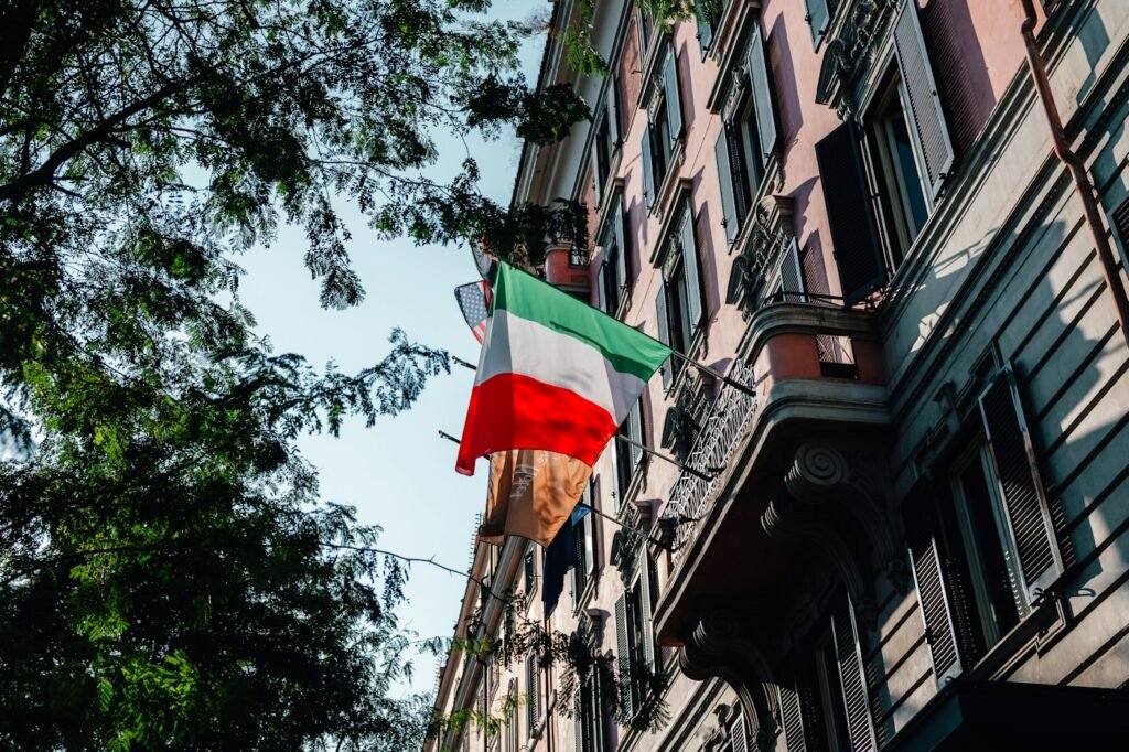 Italian flag hanging from a building on a city street