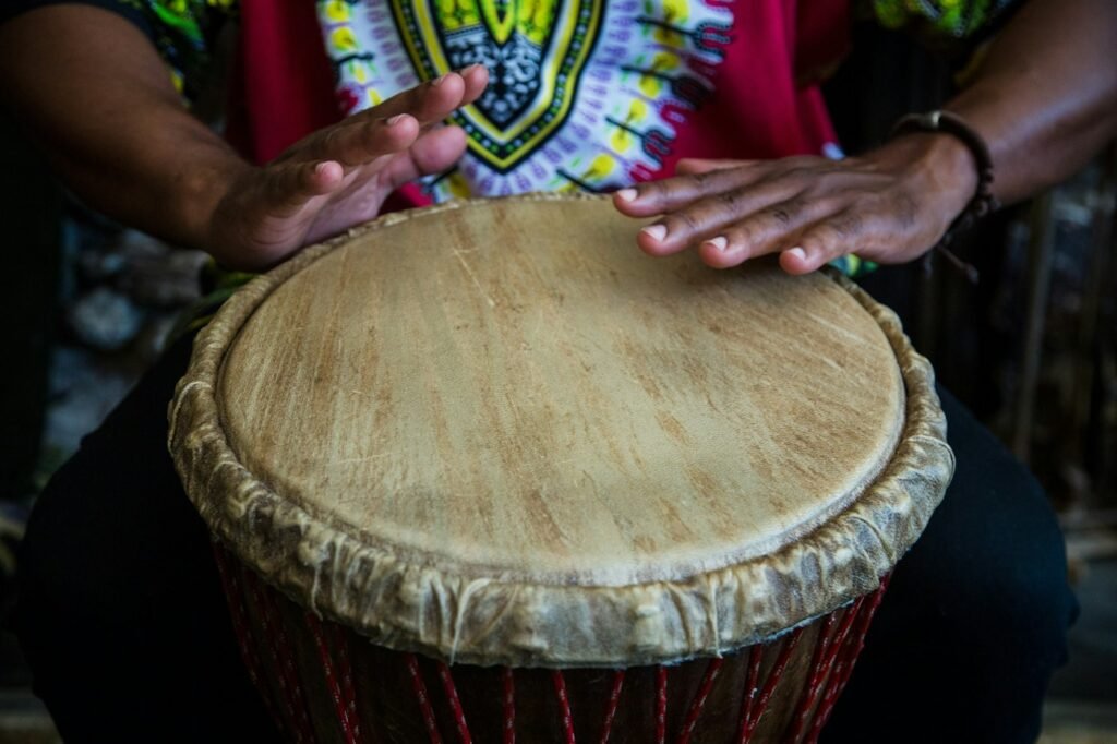 Hands playing a hand drum