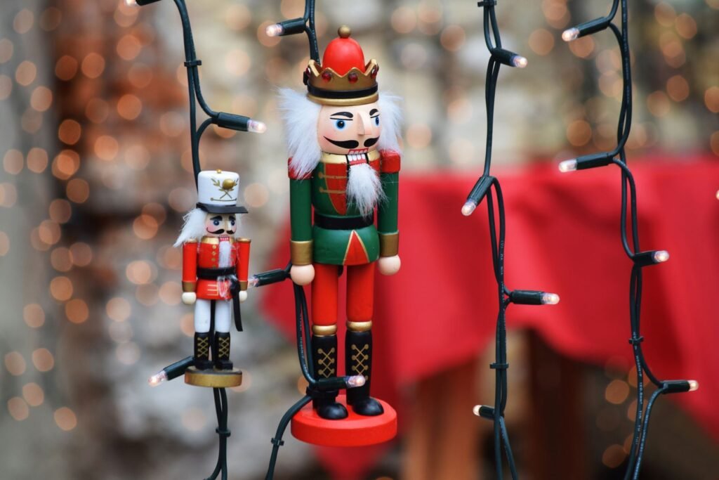 Colorful nutcracker ornaments hanging among Christmas lights.