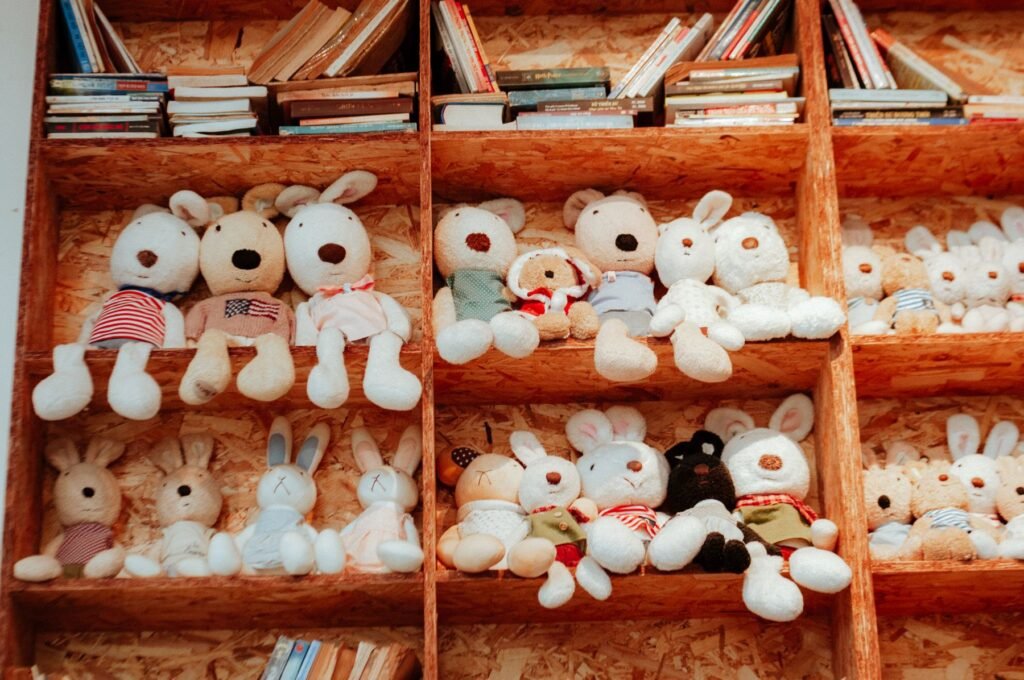 Shelves of soft toy animals and children's books.