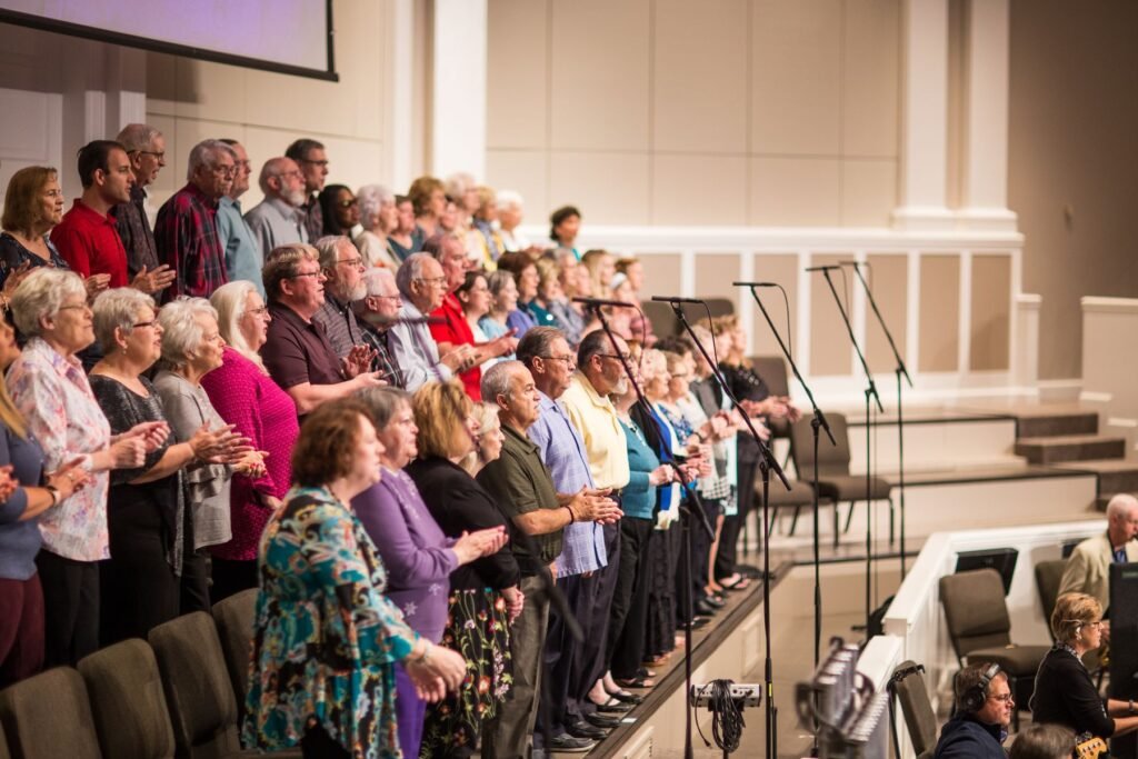 A large choir performing in a modern hall.