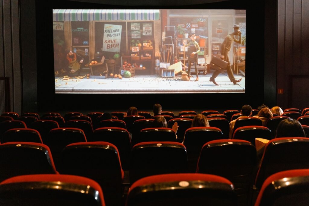 An animated film showing on a screen to a small audience.