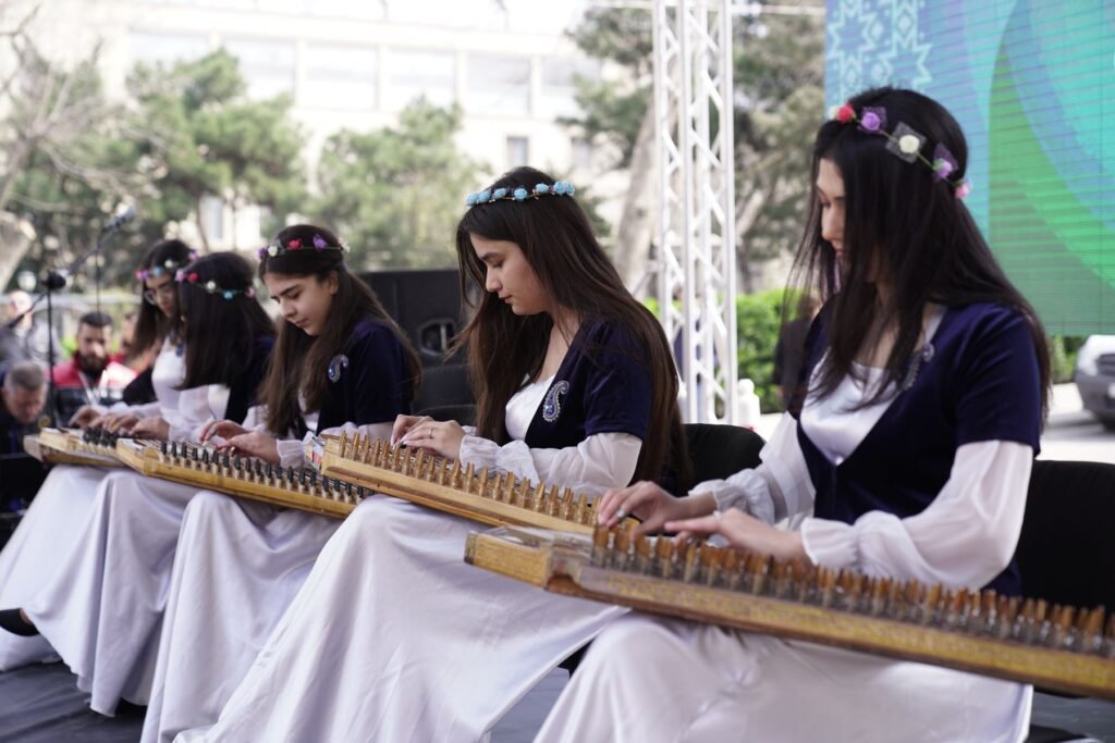 Women playing traditional string instruments.