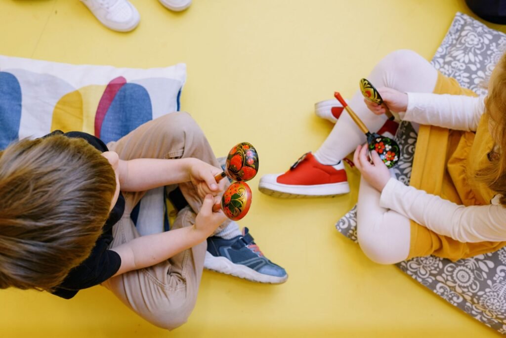 Young children playing maracas in a music class.