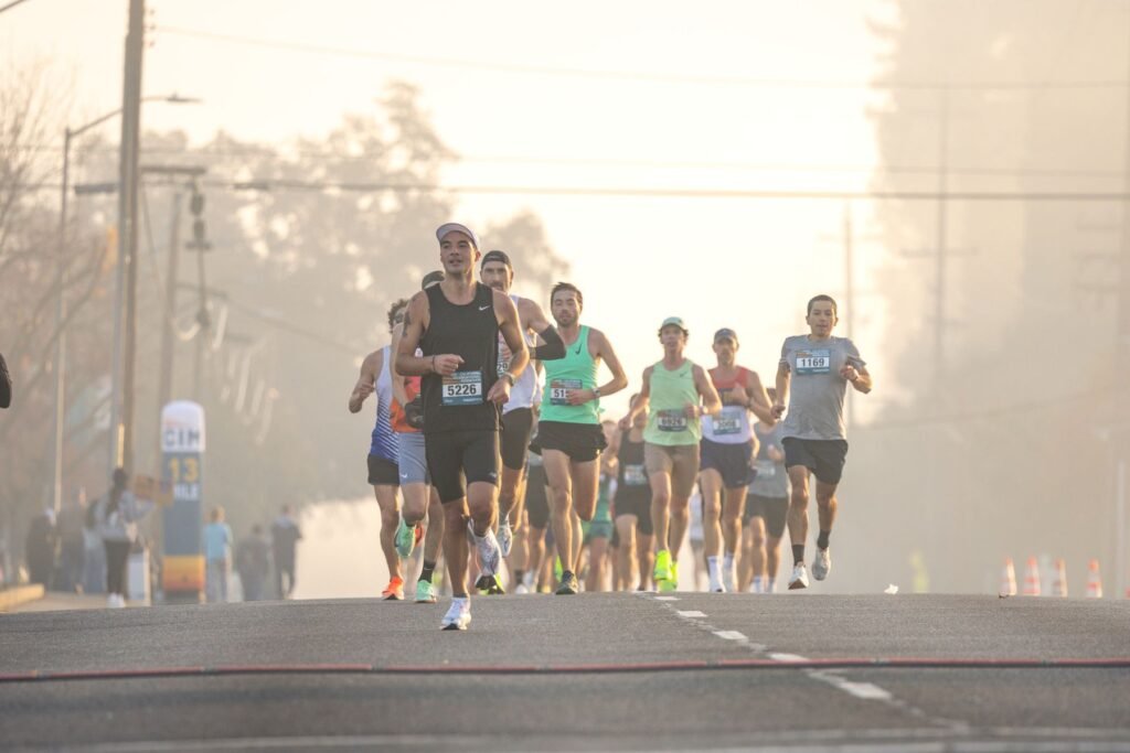 Runners in a road race on a foggy morning.