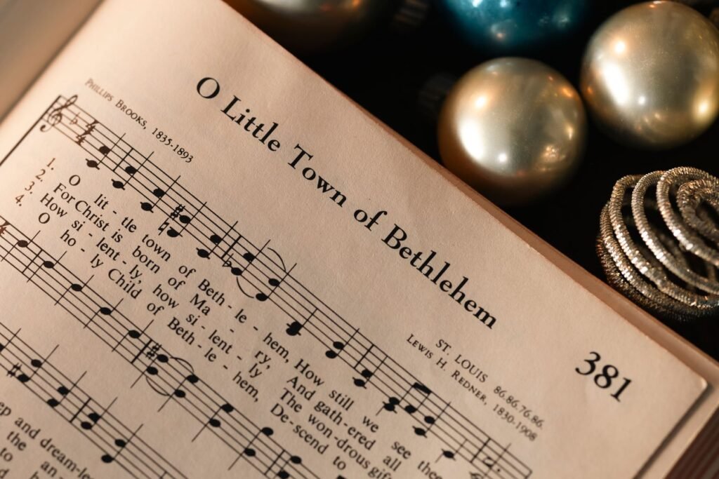 Sheet music for a Christmas carol with festive decorations.