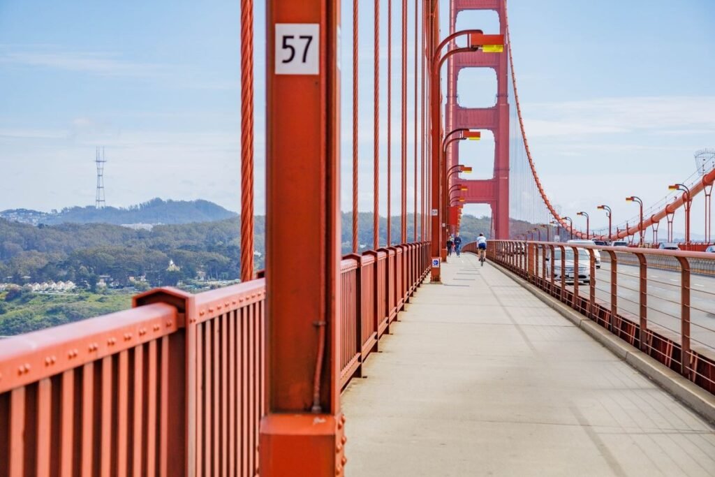 The east walkway of the Golden Gate Bridge with its red railing and tower
