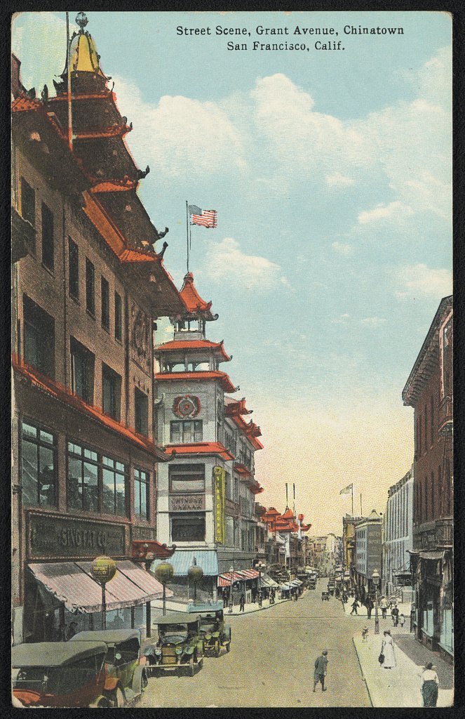 A colour postcard of Grant Avenue in San Francisco Chinatown with pagoda-style buildings and a street lined with cars