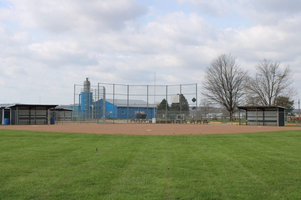 Empty baseball field with dugouts on a clear day