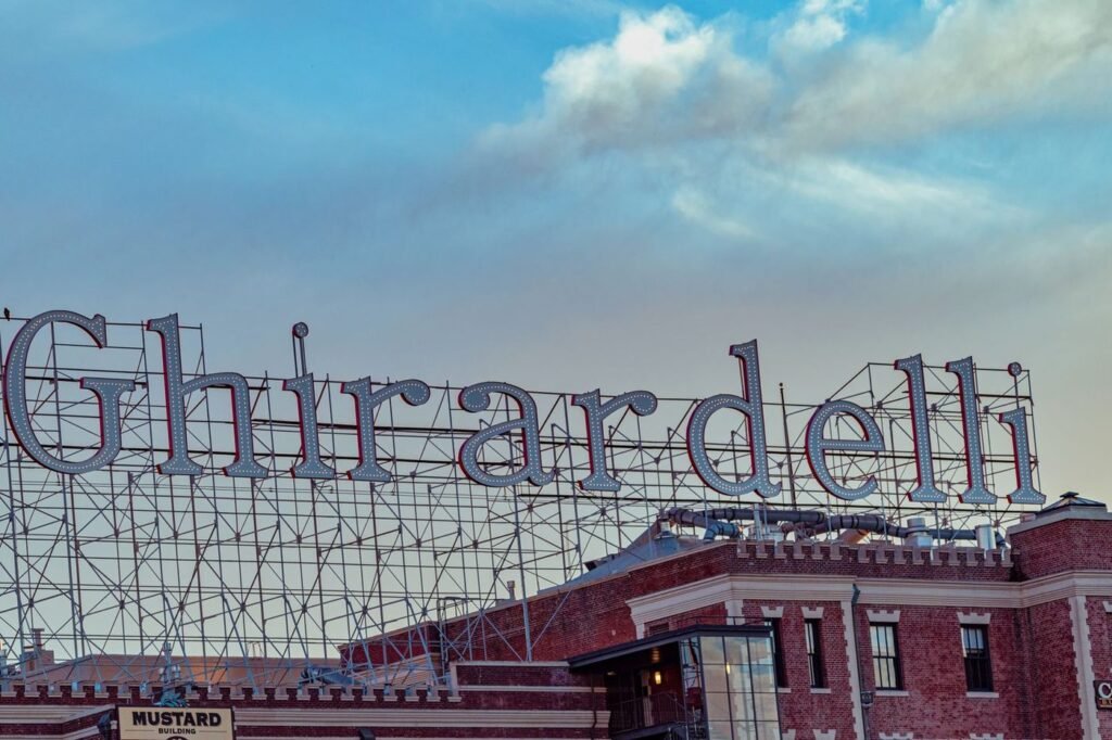 The Ghirardelli sign atop the historic brick buildings of Ghirardelli Square