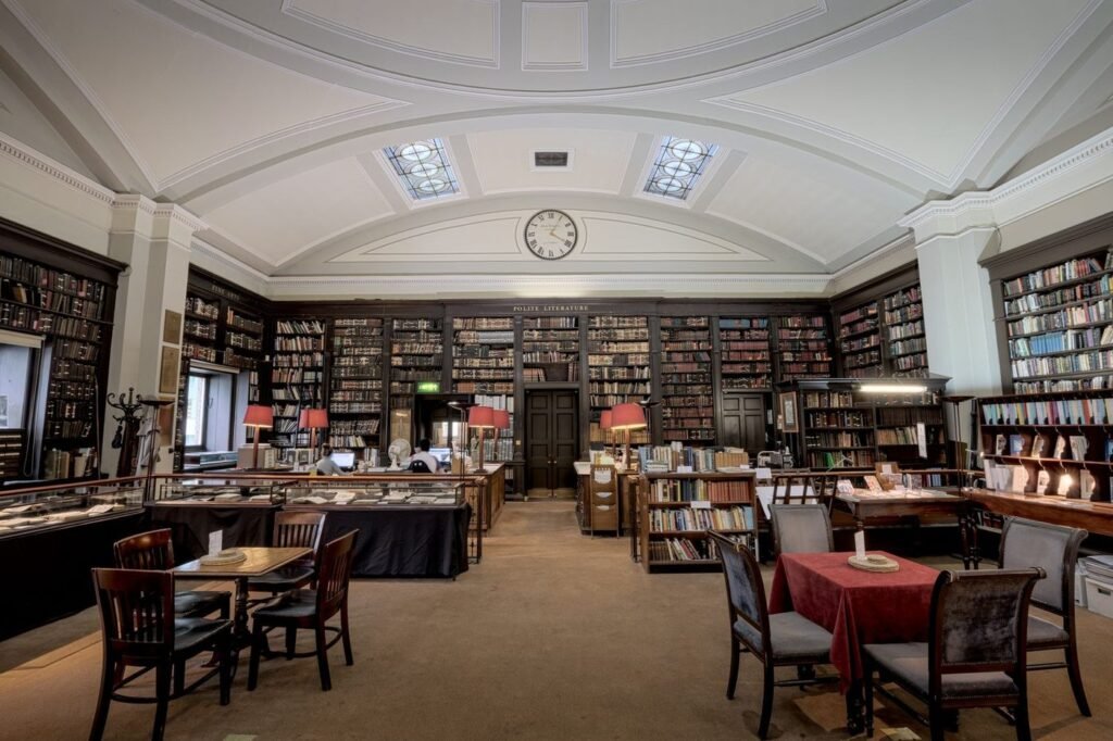 Historic library reading room with tables, chairs and bookshelves