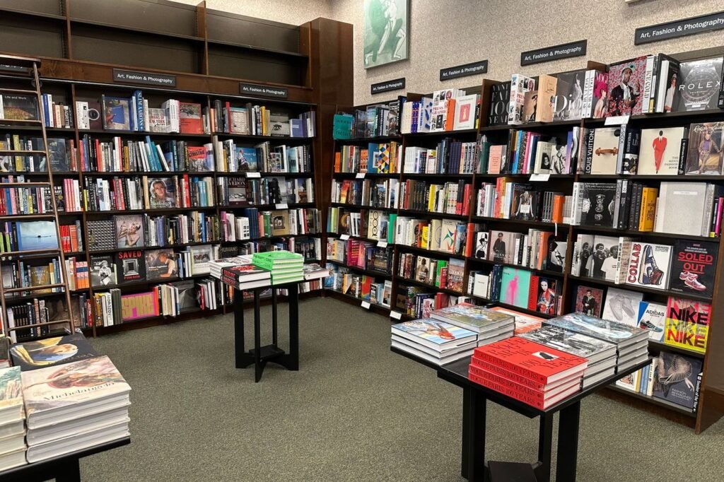 Neighborhood bookstore with wall shelves and display tables of books