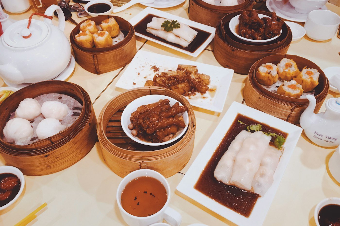 A table of dim sum baskets and tea