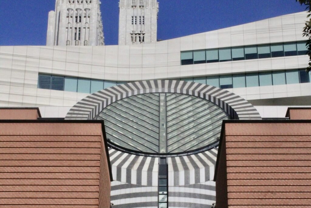SFMOMA's striped round skylight and red-brick facade, with the white Snøhetta expansion behind