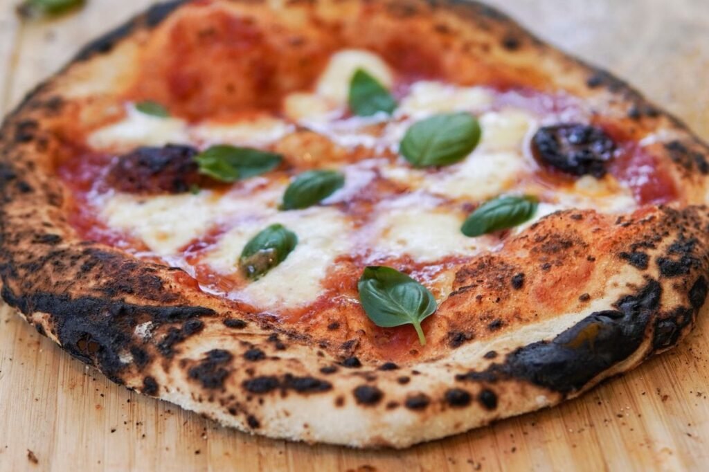 Wood-fired Margherita pizza with basil and charred crust