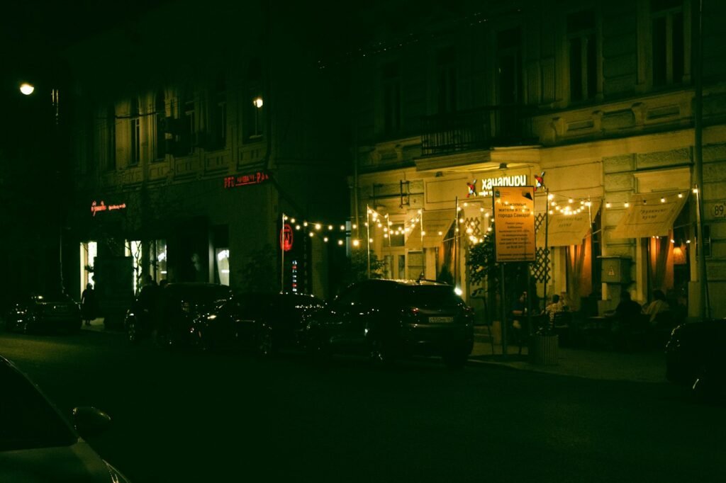 Holiday string lights over a street at night
